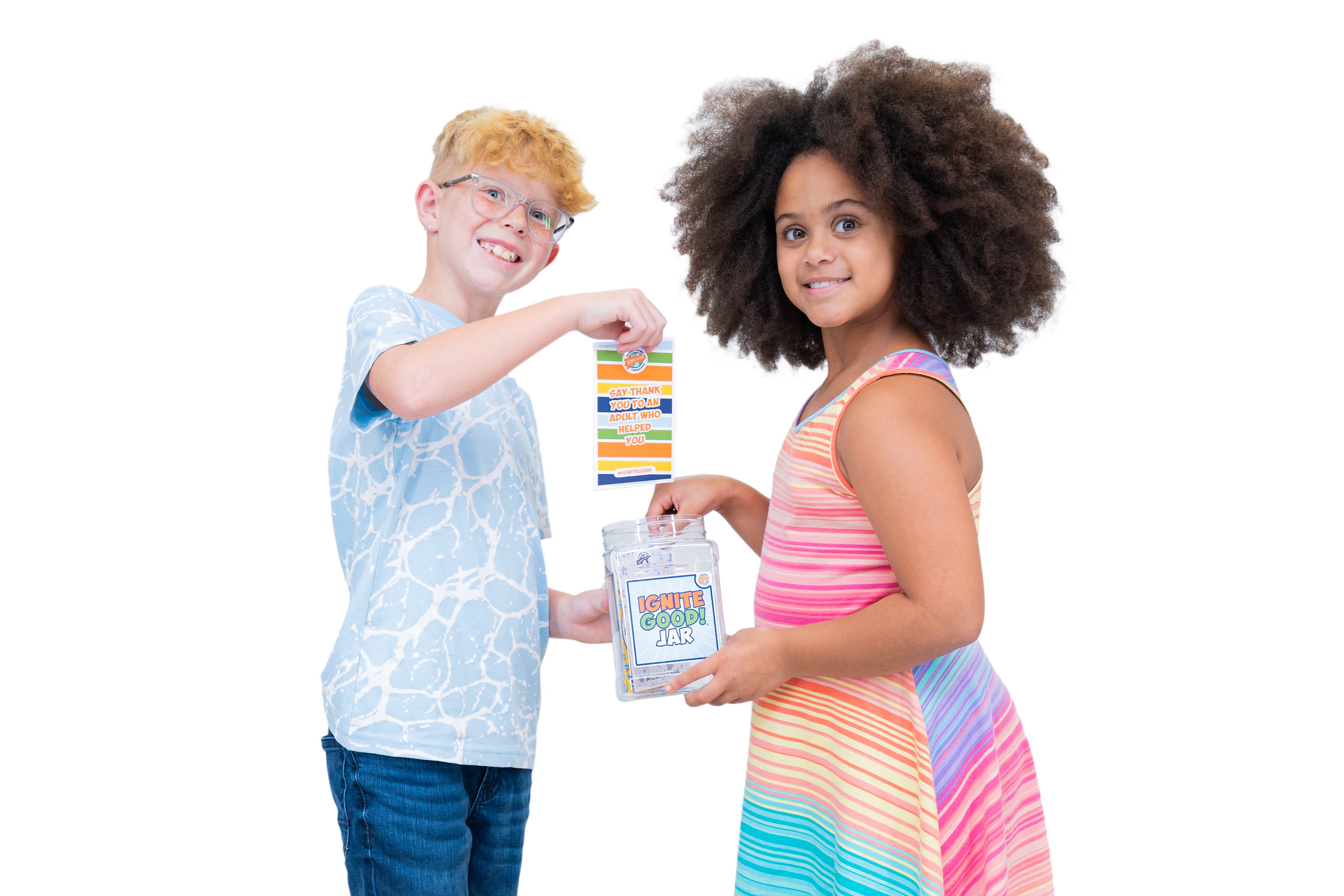 Two children holding an IGNITE GOOD! Jar against a white background