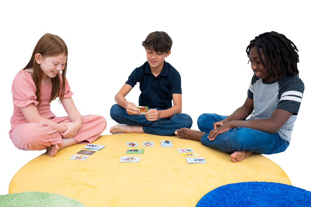 Three children sitting on a colorful rug playing with the What's Your Superpower? card game.