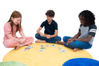 Three children sitting on a colorful rug playing with the What's Your Superpower? card game.