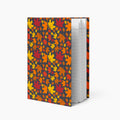 A notebook with a dark charcoal cover decorated with a dense pattern of colorful autumn maple leaves in red, orange, yellow, and brown, shown standing open against a light gray background.