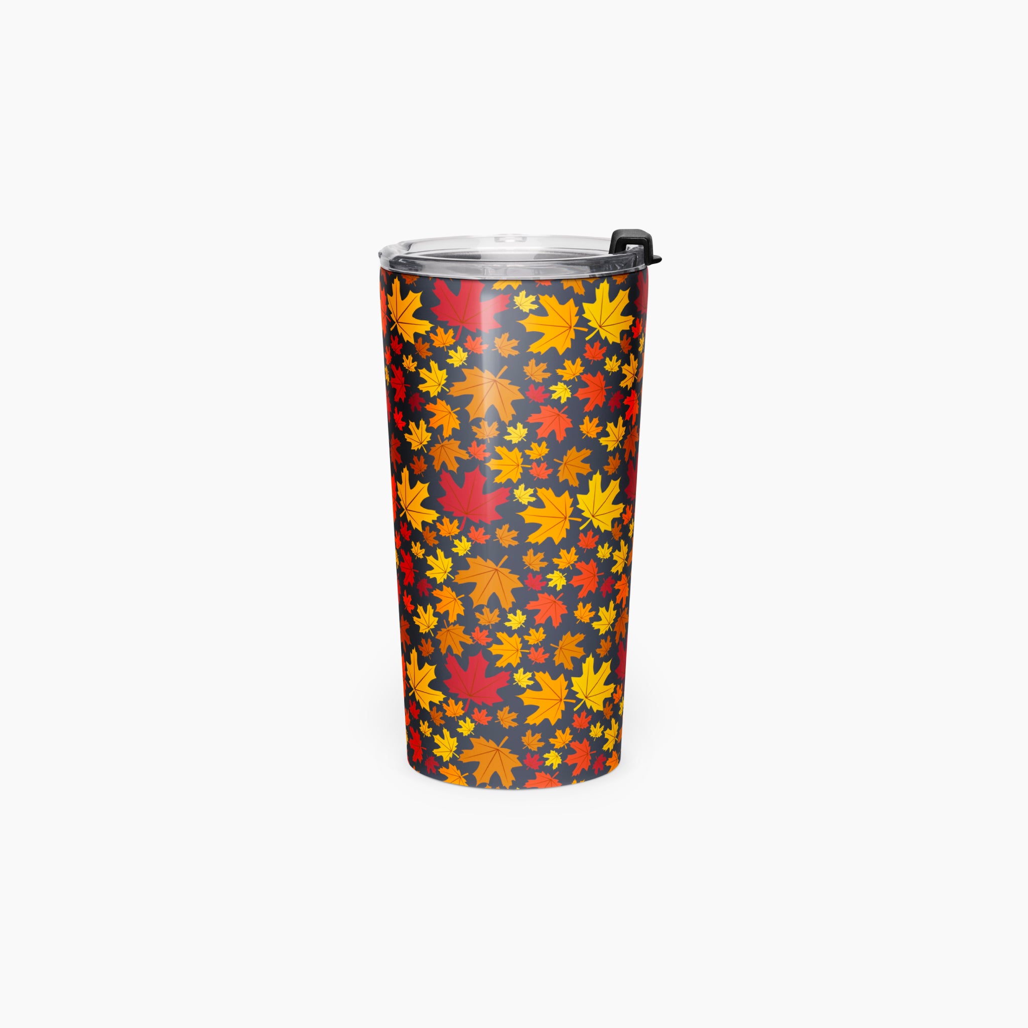 A tall insulated tumbler with a clear lid and black flip cover, featuring an all-over autumn maple leaf pattern in red, orange, and yellow on a dark background, shown on a light gray studio background.