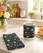 Custom printed Blue Floral mug and matching notebook on a kitchen counter with flowers and scones in the background