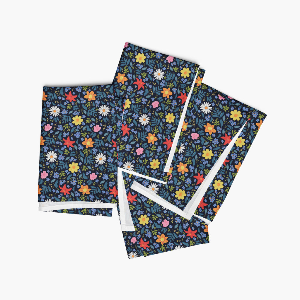 Set of four blue floral-patterned cloth napkins on a white background