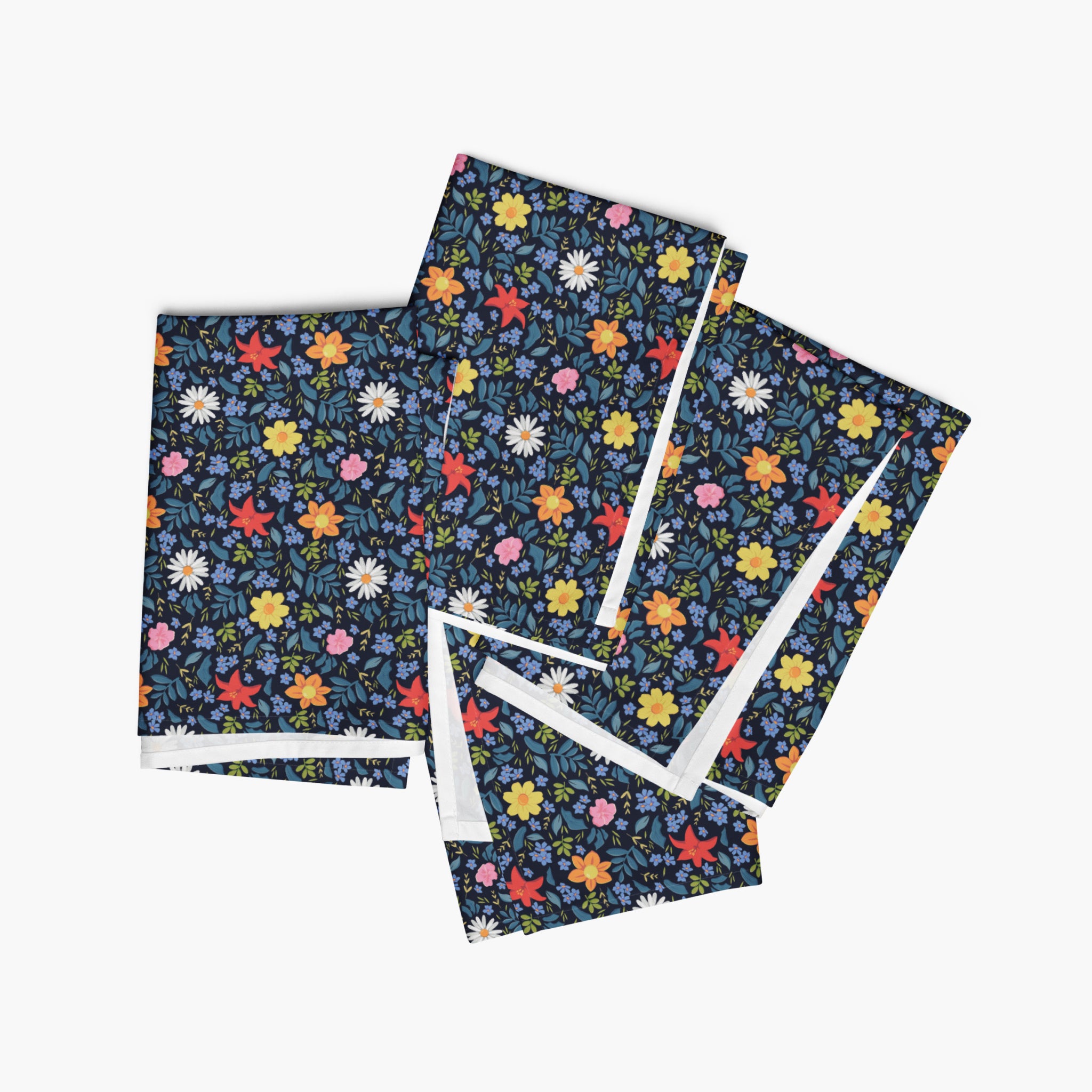 Set of four blue floral-patterned cloth napkins on a white background