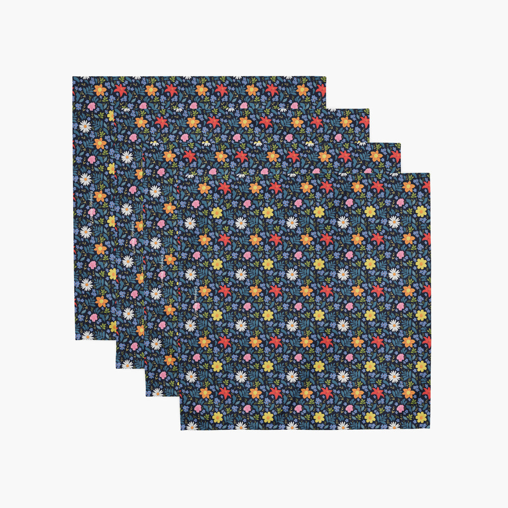 Set of four blue floral cloth napkins on a white background