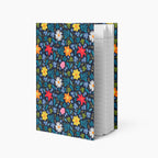 Hardcover journal with blue floral patterned cover design and lined pages on a white background