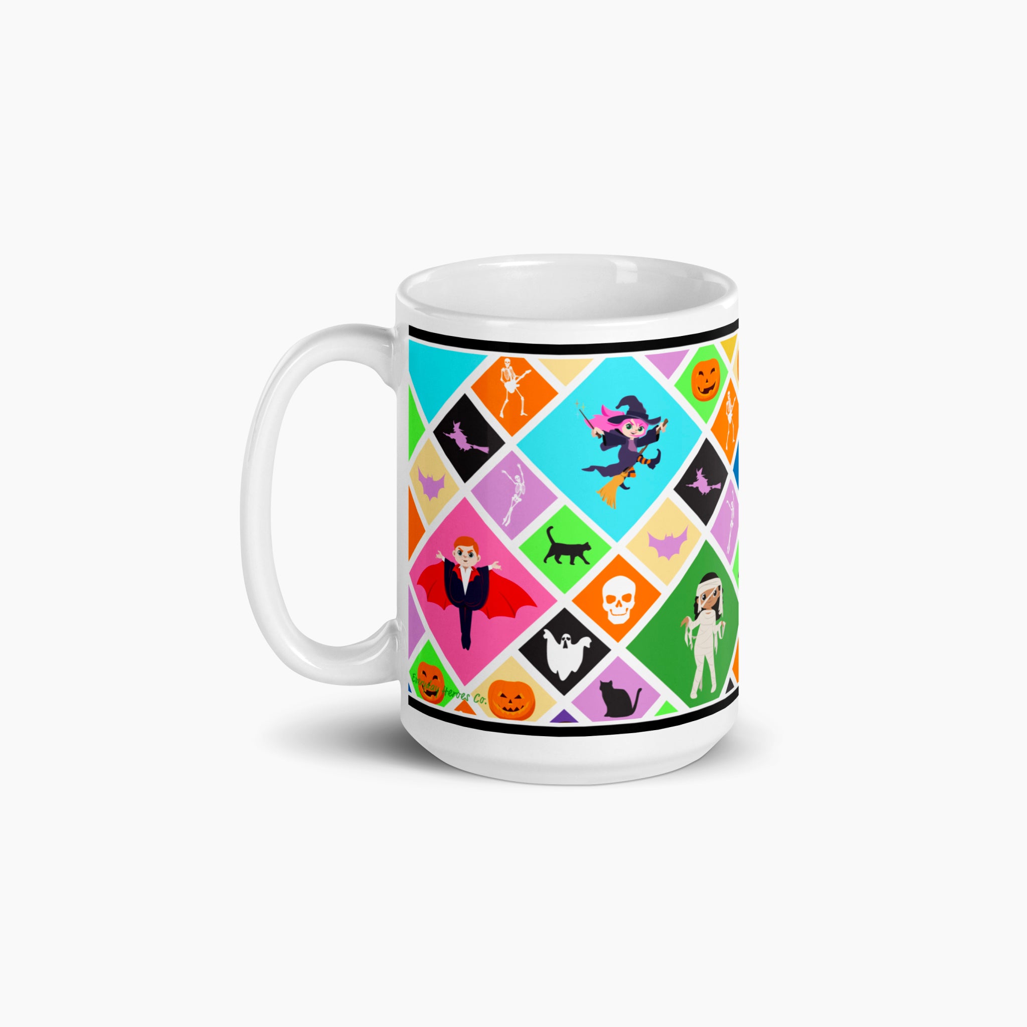 A white ceramic mug with a colorful Halloween-themed diamond pattern featuring pumpkins, ghosts, bats, a skeleton, and cartoon kids in costumes, shown on a light gray background.