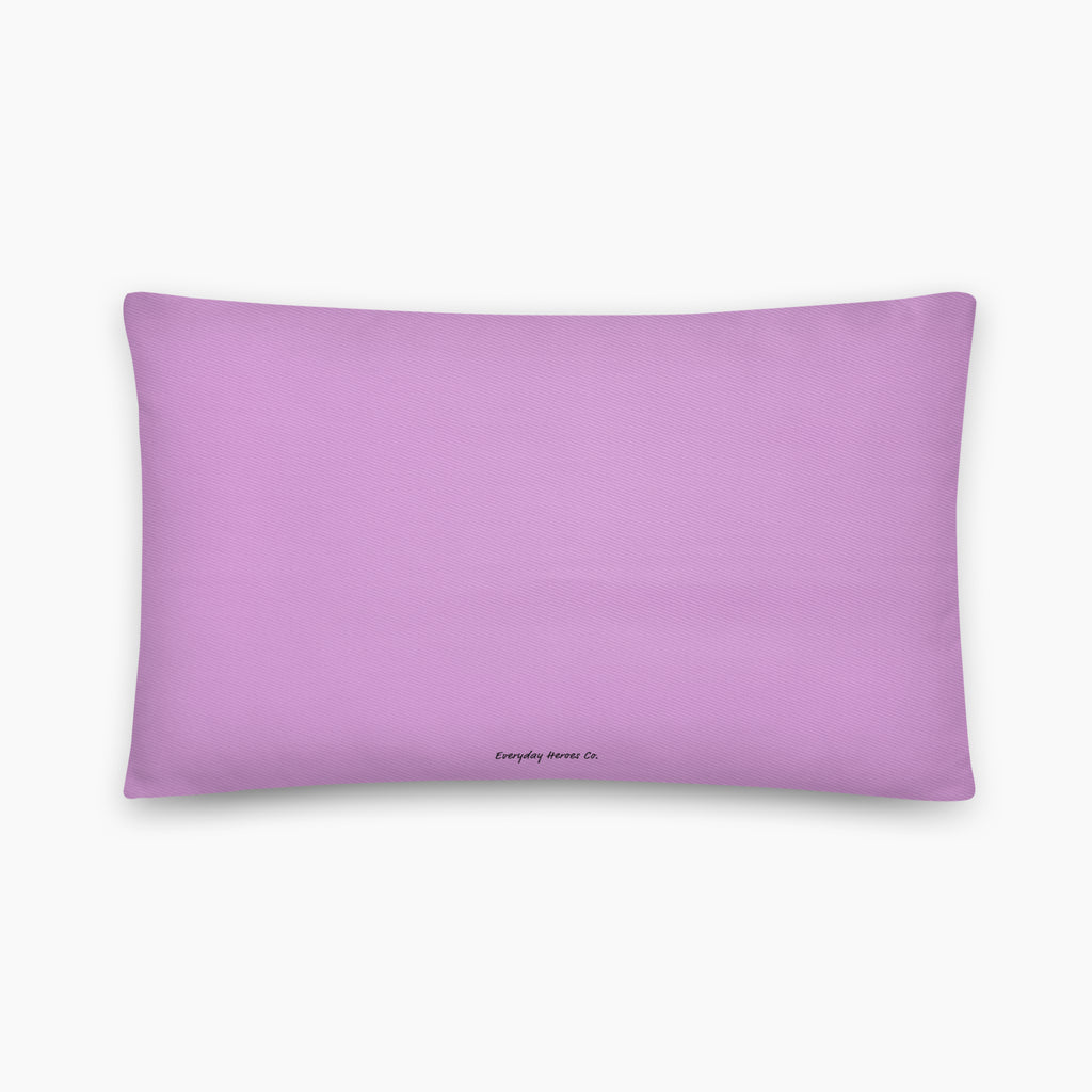 The back of a rectangular lavender colored throw pillow with a small black printed logo at the bottom center, displayed on a clean light grey background.