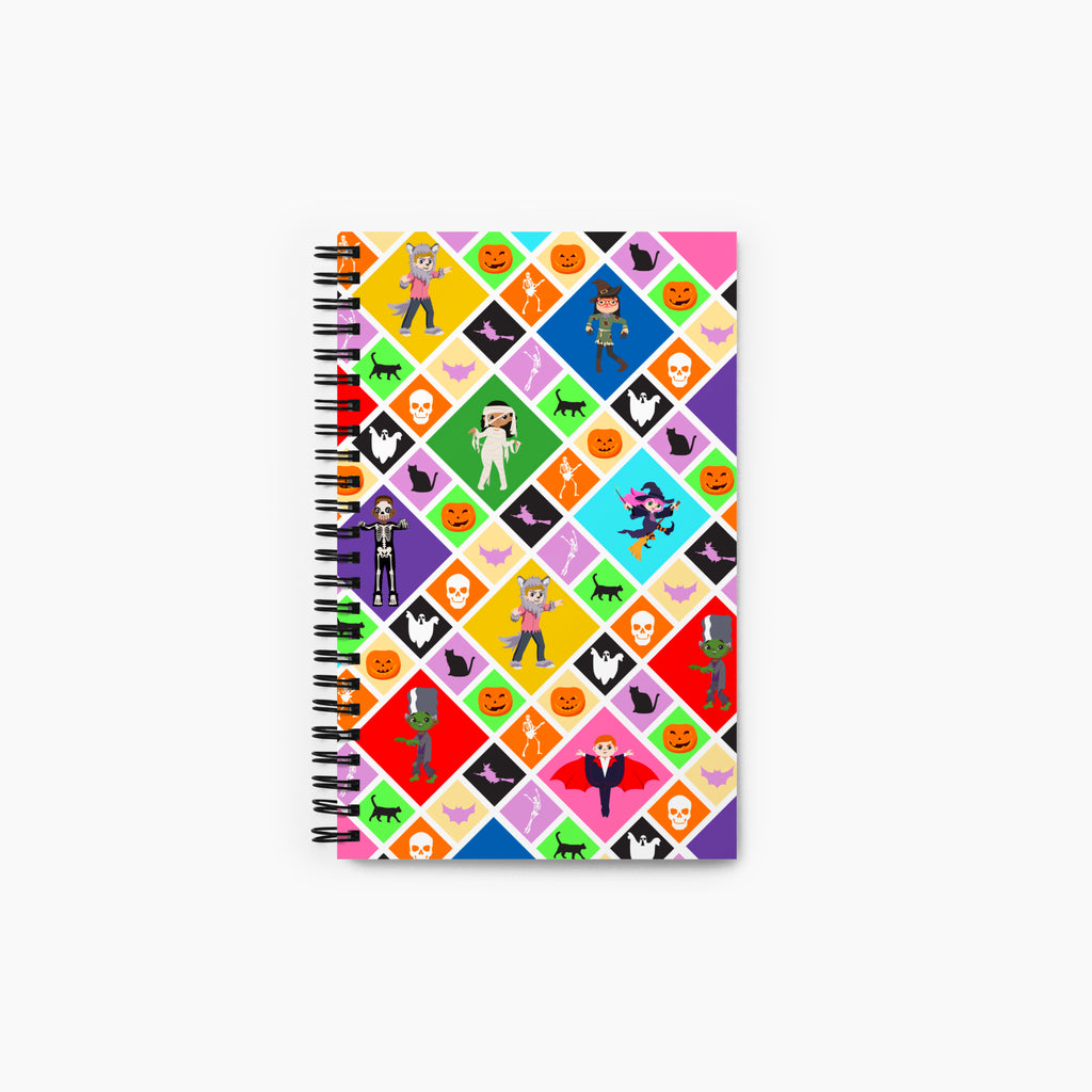 A front cover of a spiral-bound notebook featuring a Halloween-themed diamond pattern with pumpkins, ghosts, bats, a skeleton, and cartoon kids in costumes, shown on a light gray background.