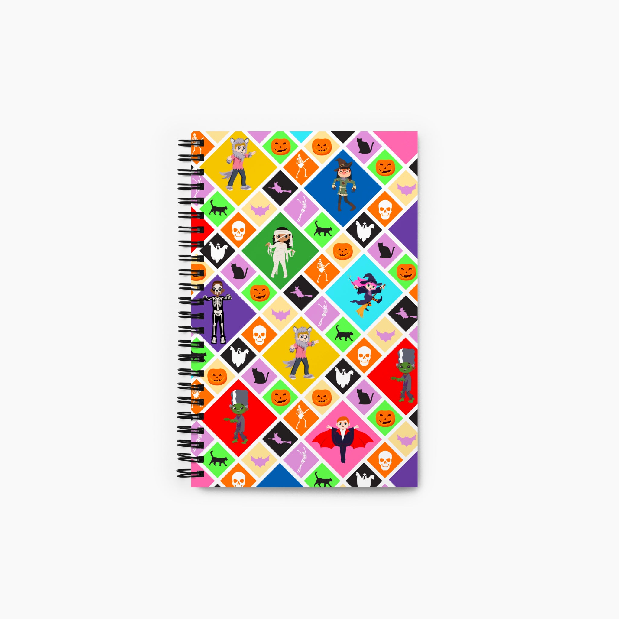 A front cover of a spiral-bound notebook featuring a Halloween-themed diamond pattern with pumpkins, ghosts, bats, a skeleton, and cartoon kids in costumes, shown on a light gray background.
