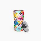 A stainless steel travel tumbler with a colorful diamond-patterned Halloween design, featuring cartoon kids in costumes shown with its clear plastic lid resting beside it on a light gray background.