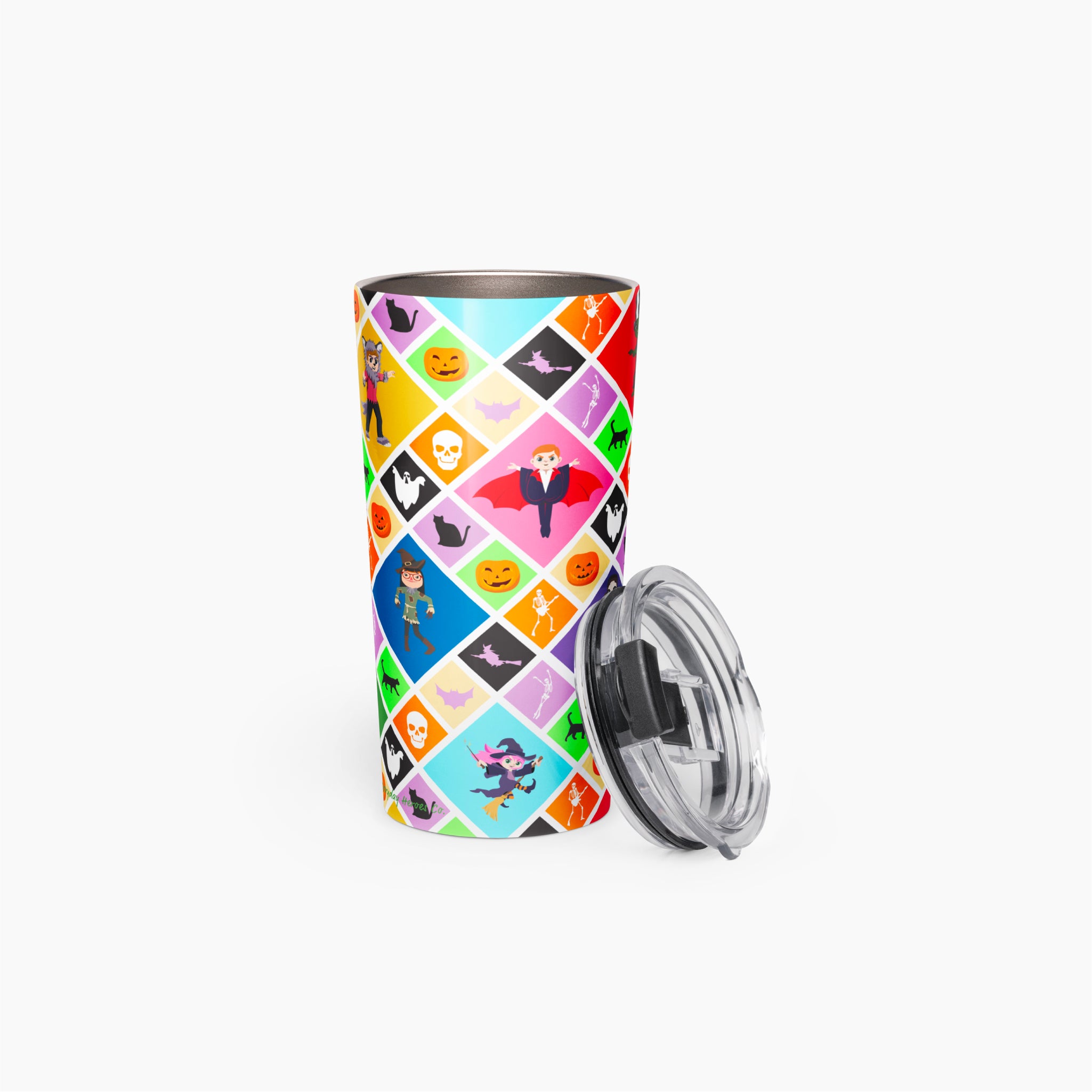 A stainless steel travel tumbler with a colorful diamond-patterned Halloween design, featuring cartoon kids in costumes shown with its clear plastic lid resting beside it on a light gray background.