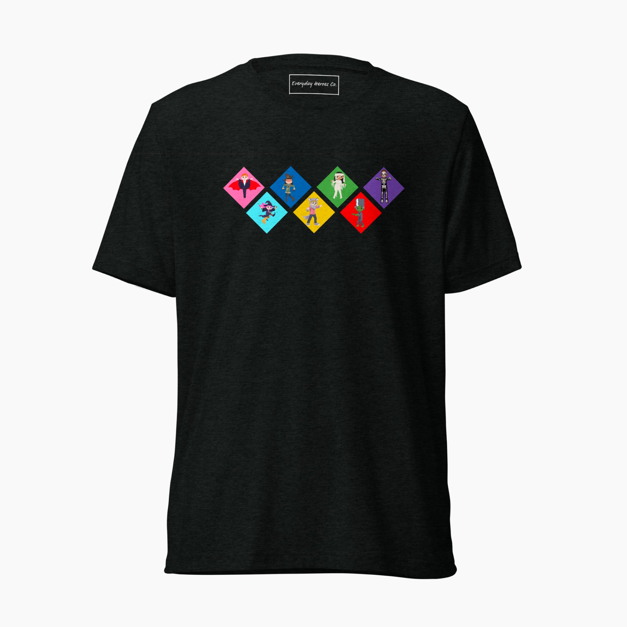 A black short-sleeve t-shirt with a colorful graphic on the chest depicting seven diamond-shapes with various Global Game Changers cartoon kids dressed up in Halloween Costumes, shown against a plain light grey background.
