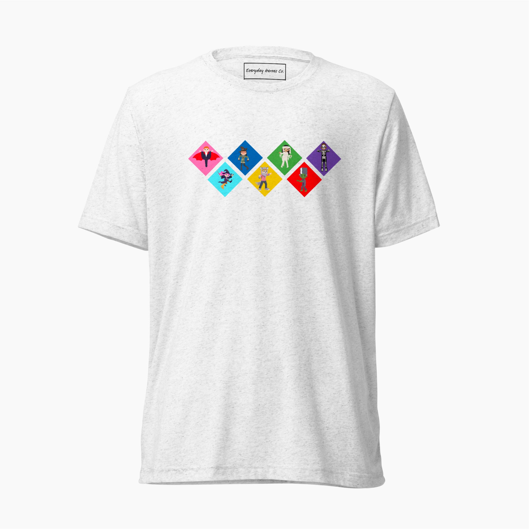 A white short-sleeve t-shirt with a colorful graphic on the chest depicting seven diamond-shapes with various Global Game Changers cartoon kids dressed up in Halloween Costumes, shown against a plain light grey background.