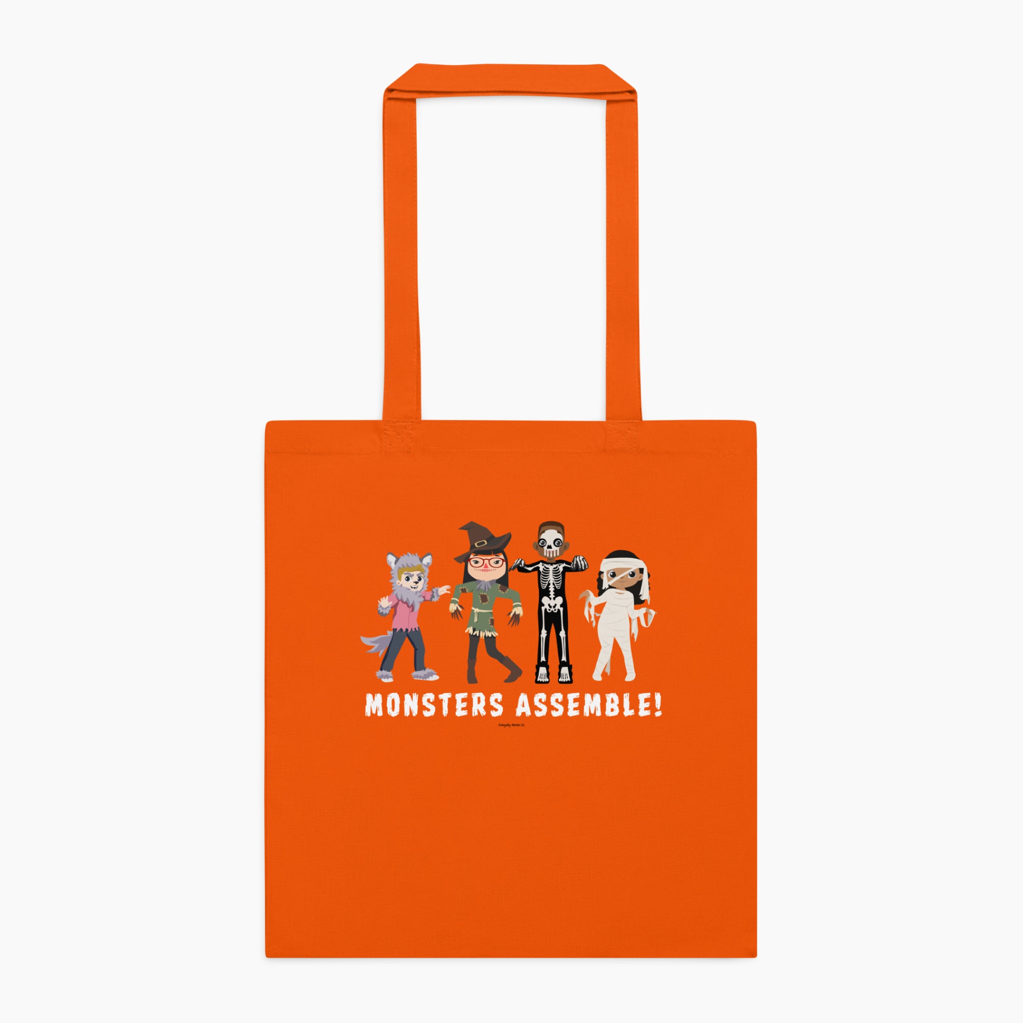 An orange canvas tote bag with orange handles, featuring a graphic of four cartoon monsters and the text 'MONSTERS ASSEMBLE!' printed on the front, set against a plain light grey background.