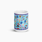 White mug with light blue dog-themed design on a white background
