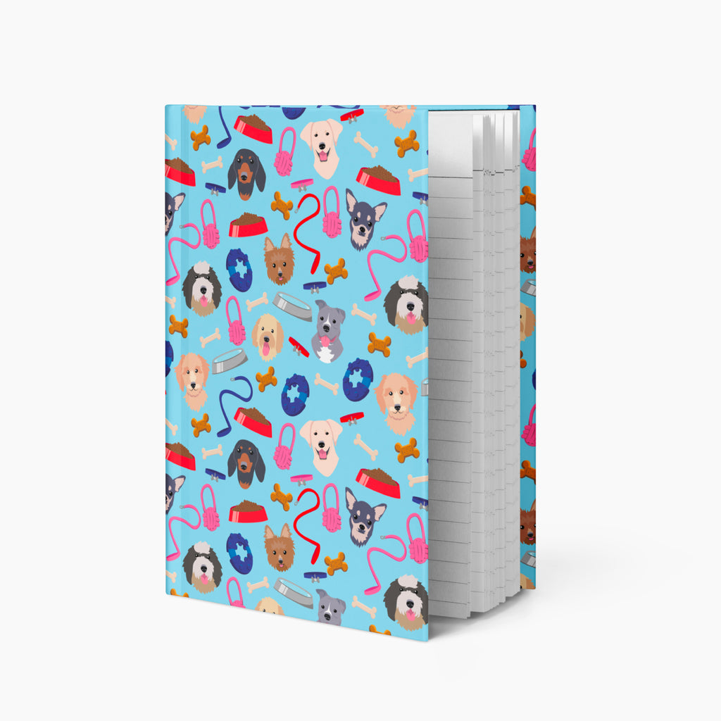 Hardcover journal with dog gear patterned cover design and lined pages on a white background