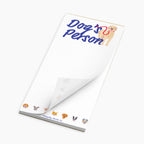 Notepad with 'Dog's Petson' text and dog illustrations on a white background
