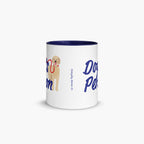 White mug with navy interior and handle, featuring a dog illustration and text on a white background.