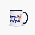 Mug with navy handle and interior with 'Dog's Person' text and dog illustration on a white background