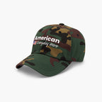 Camouflage baseball cap with 'American Everyday Hero' text on a white background