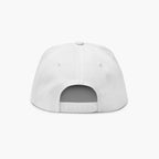 Back of white flat billed cap on a light gray background