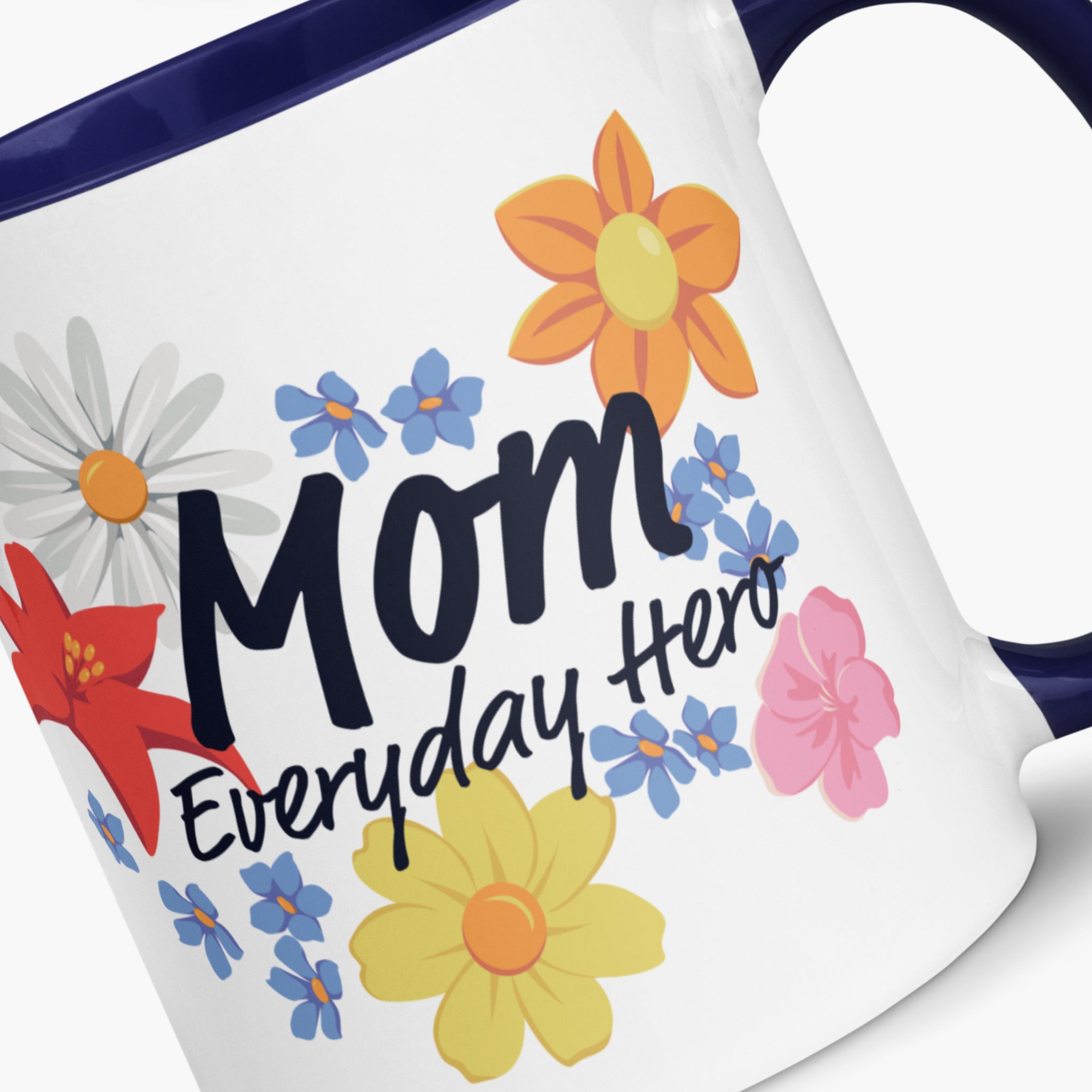 Mug with navy handle and interior featuring 'Mom Everyday Hero' text and colorful flowers on a white background