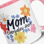 Mug with pink handle and interior featuring 'Mom Everyday Hero' text and colorful flowers on a white background