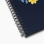 Spiral notebook with floral design on a white background