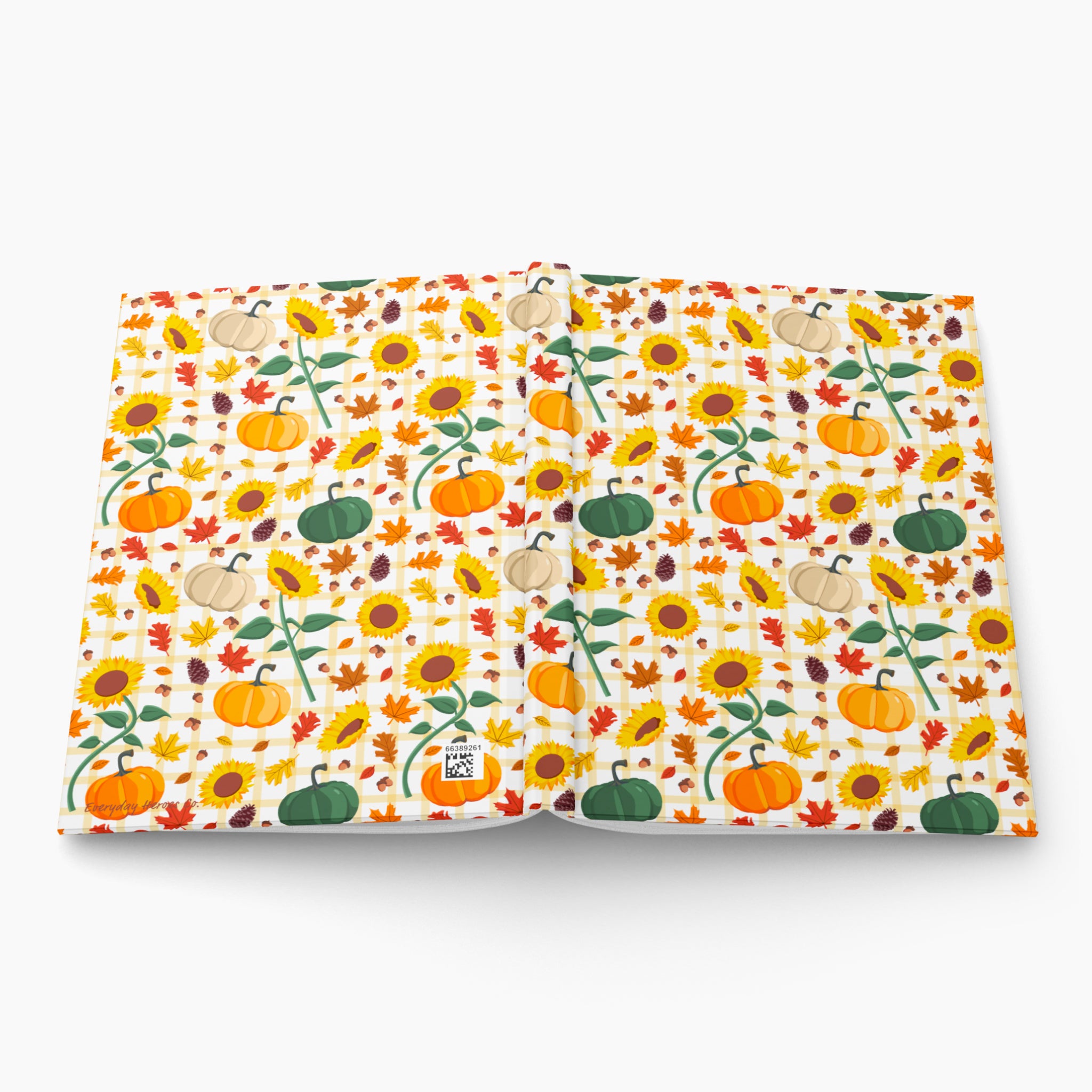 Front and back cover of a hardcover journal featuring a colorful autumn pattern of pumpkins, sunflowers, and leaves on a white background, photographed on a light gray background.