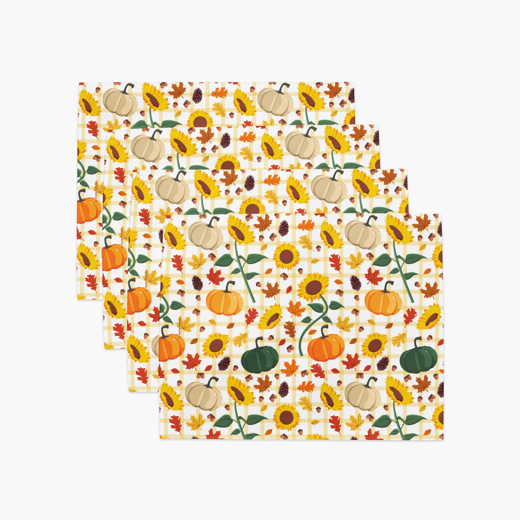 Set of 4 rectangular placemats with a colorful autumn pattern featuring pumpkins, sunflowers, maple leaves, and acorns on a light-grey background, arranged in a staggered stack.