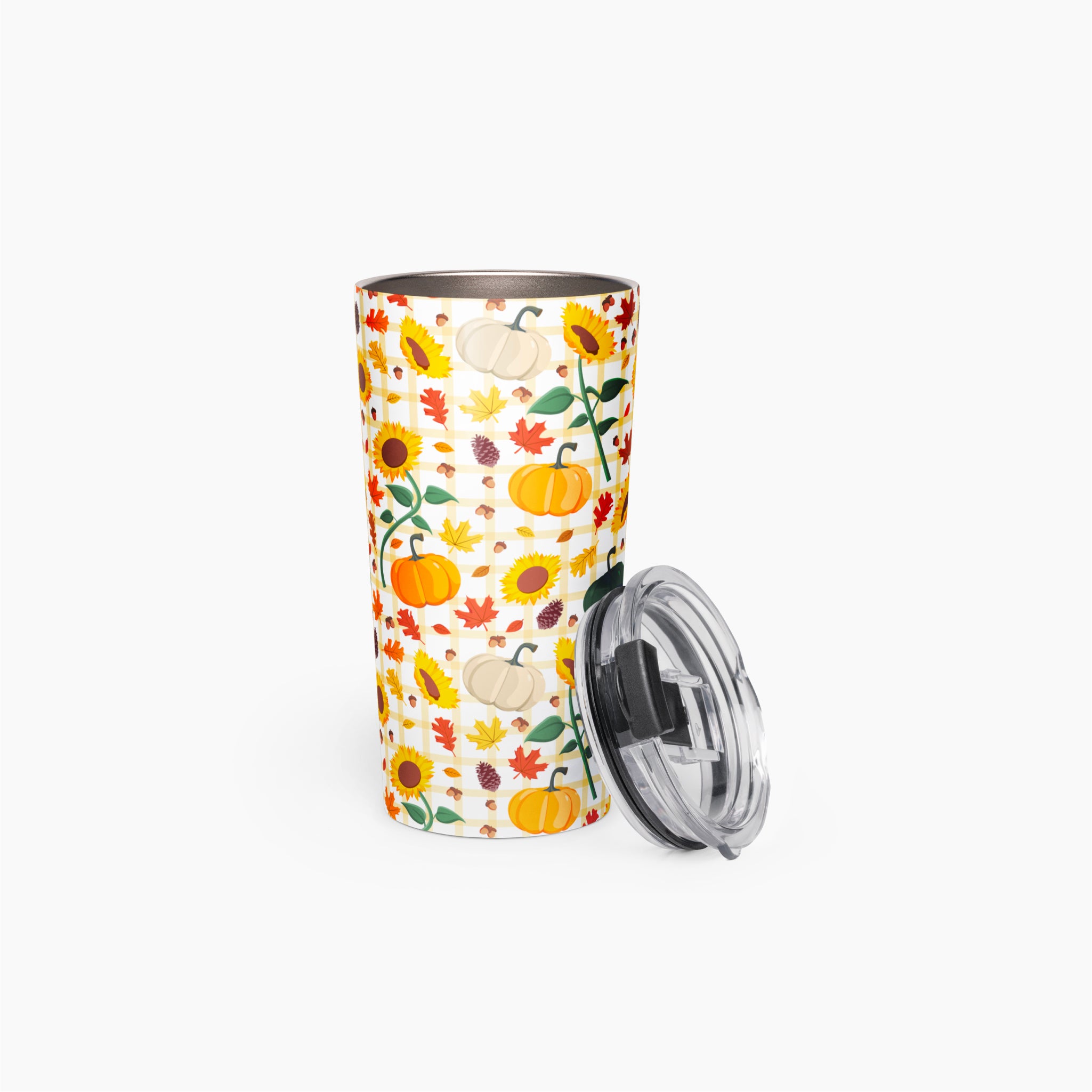 A tall insulated travel tumbler with a white background and a colorful autumn pattern featuring pumpkins, sunflowers, leaves, and acorns, shown with a clear plastic lid on a light gray background.