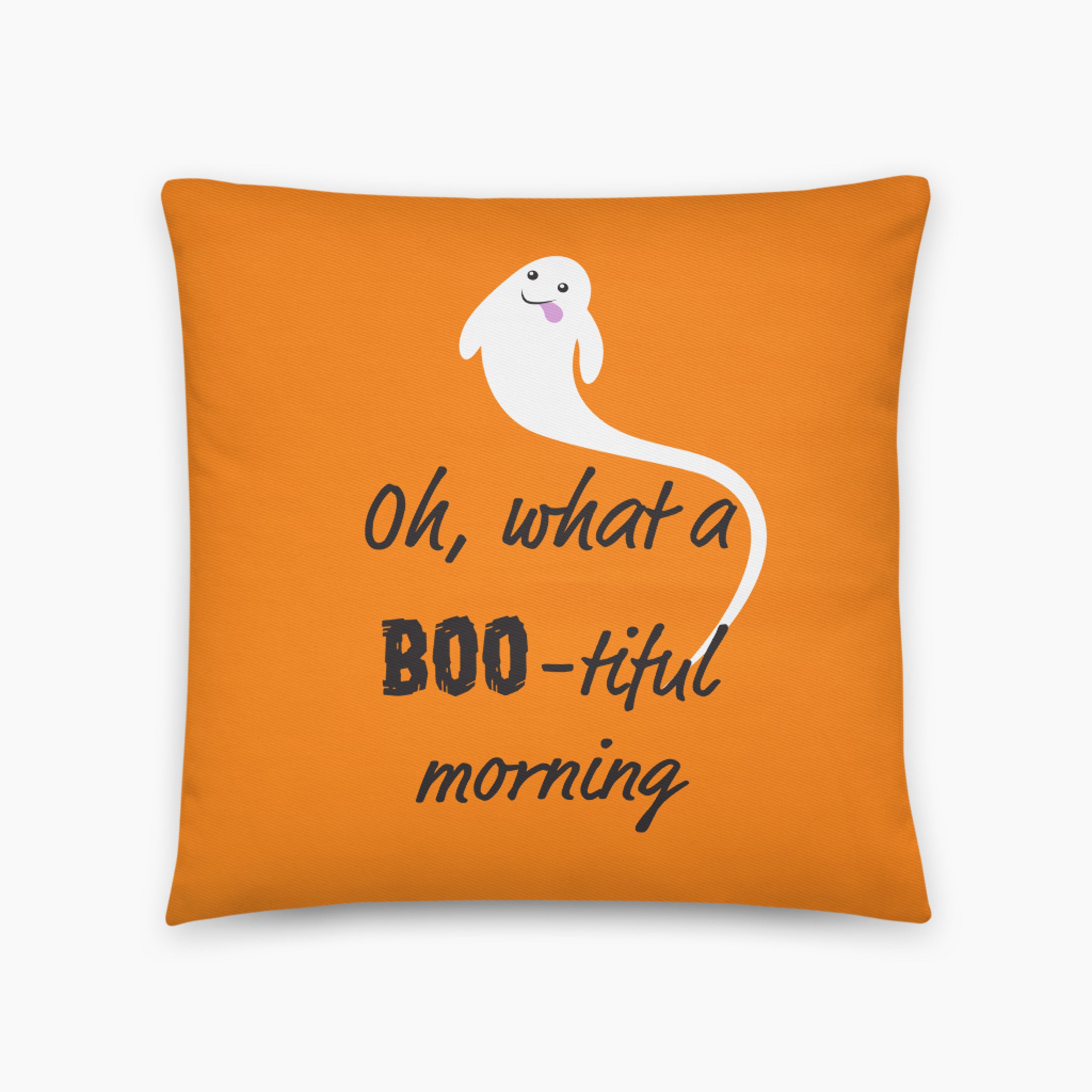 An orange square throw pillow featuring a white cartoon ghost and the text 'Oh, what a BOO-tiful morning' in black script, shown on a light gray background.