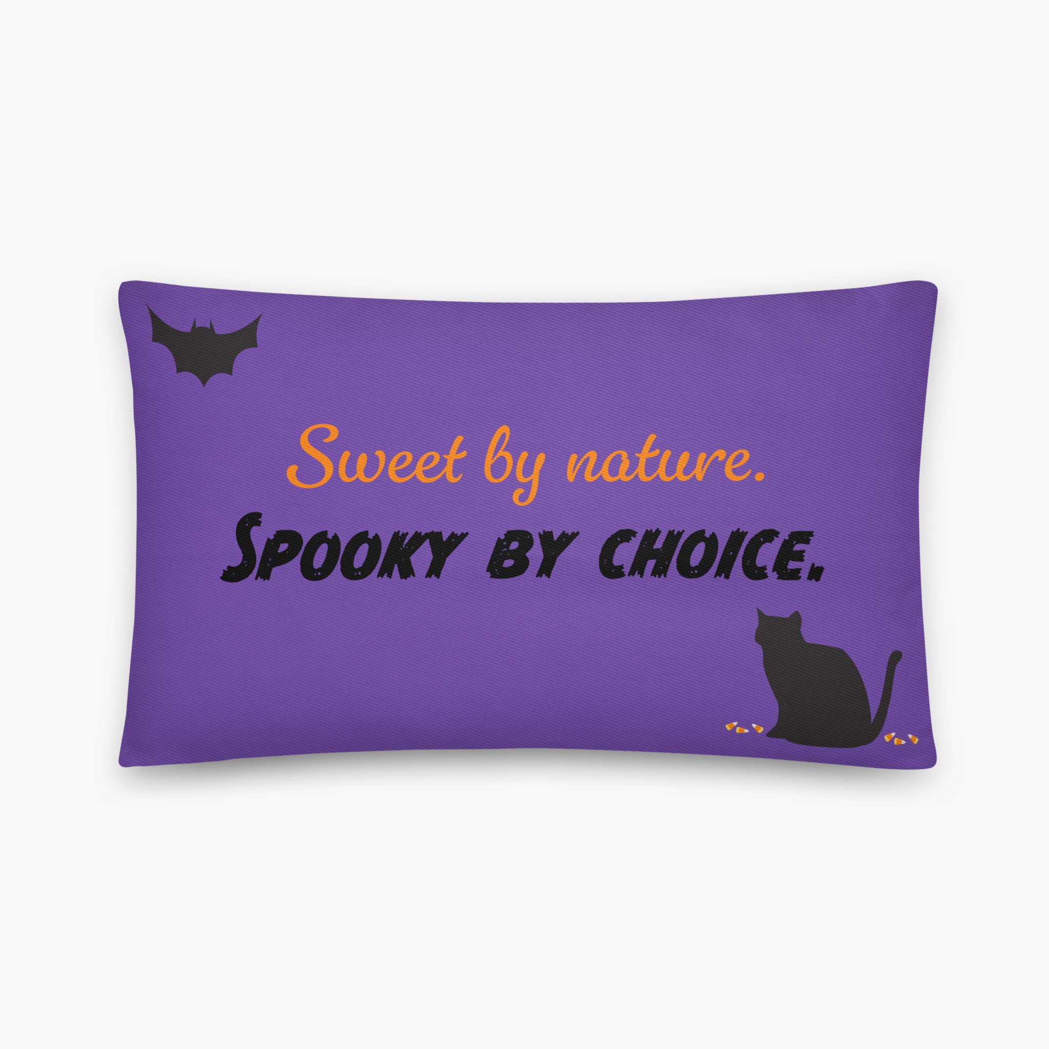 A rectangular purple throw pillow with a Halloween-themed design including a black bat and cat. The design features the text 'Sweet by nature. Spooky by Choice' staged on a light grey background.