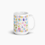 White mug with colorful birthday-themed design on a white background