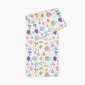 Table runner with a colorful birthday-themed pattern on a white background