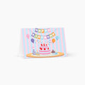 Birthday card with a cake and balloons design on a white background