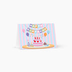 Birthday card with a cake and balloons design on a white background