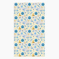 A rectangular microfiber fabric hand towel with a repeating festive pattern featuring blue menorahs, blue Star of David motifs, blue circular medallions, gold stars, and small gold and blue doves on a pale cream background.