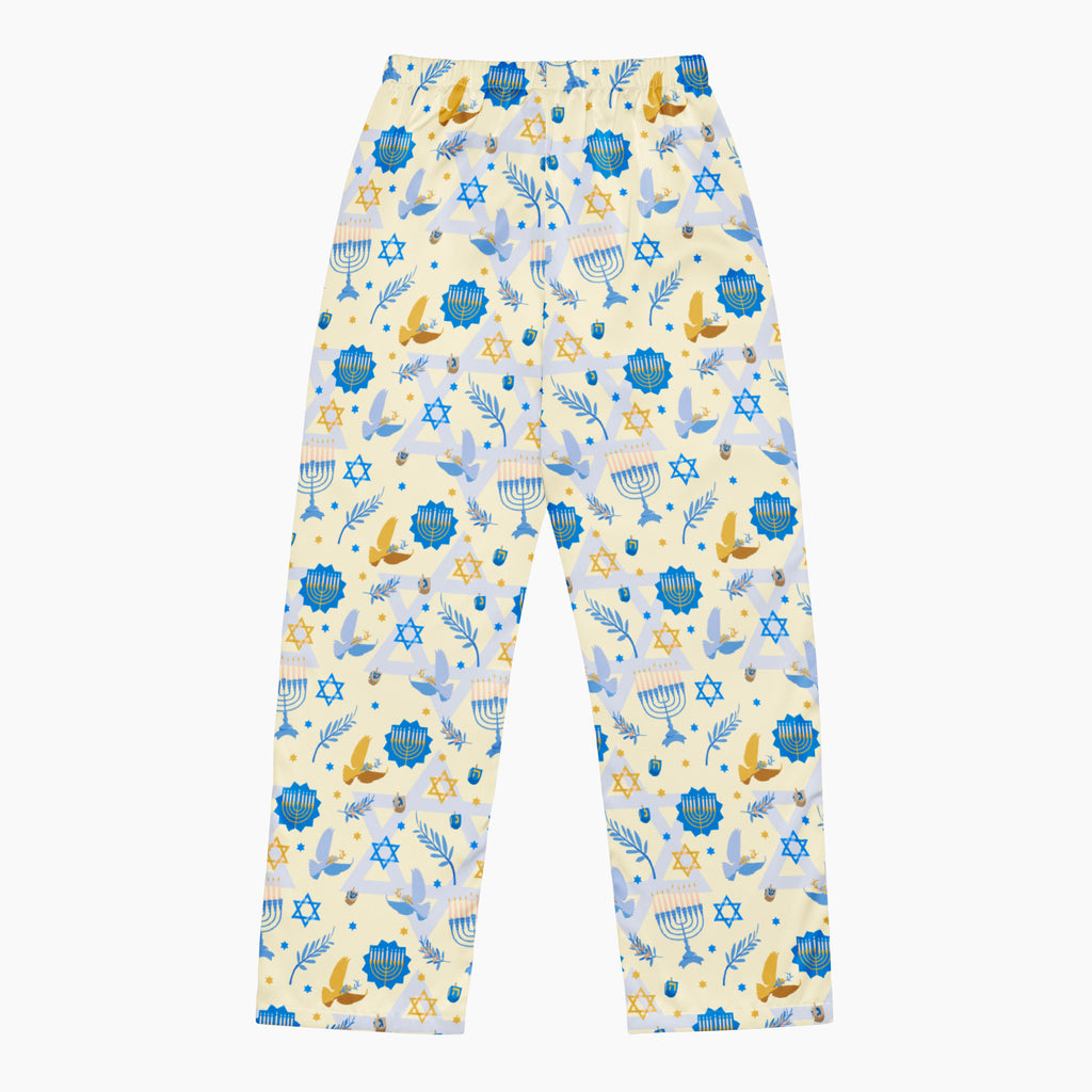 The back of a pair of pajama pants with a festive Hanukkah holiday print featuring blue menorahs, Star of David symbols, dreidels, olive branches, and doves on a pale yellow background, complete with a blue drawstring waist.