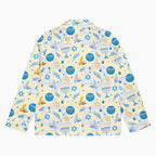The back side of a long-sleeve button-up pajama shirt with a festive Hanukkah-themed print featuring blue menorahs, Star of David emblems, lulav and olive branches and gold and blue doves on a pale yellow background.