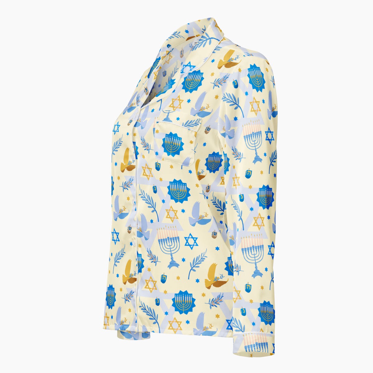 A long-sleeve button-up shirt with a light cream background and a colorful pattern of blue and gold Hanukkah-themed symbols, including Star of David, Menorahs, dreidels, olive brances, and gold and blue doves, shown from the side on a plain light grey background.