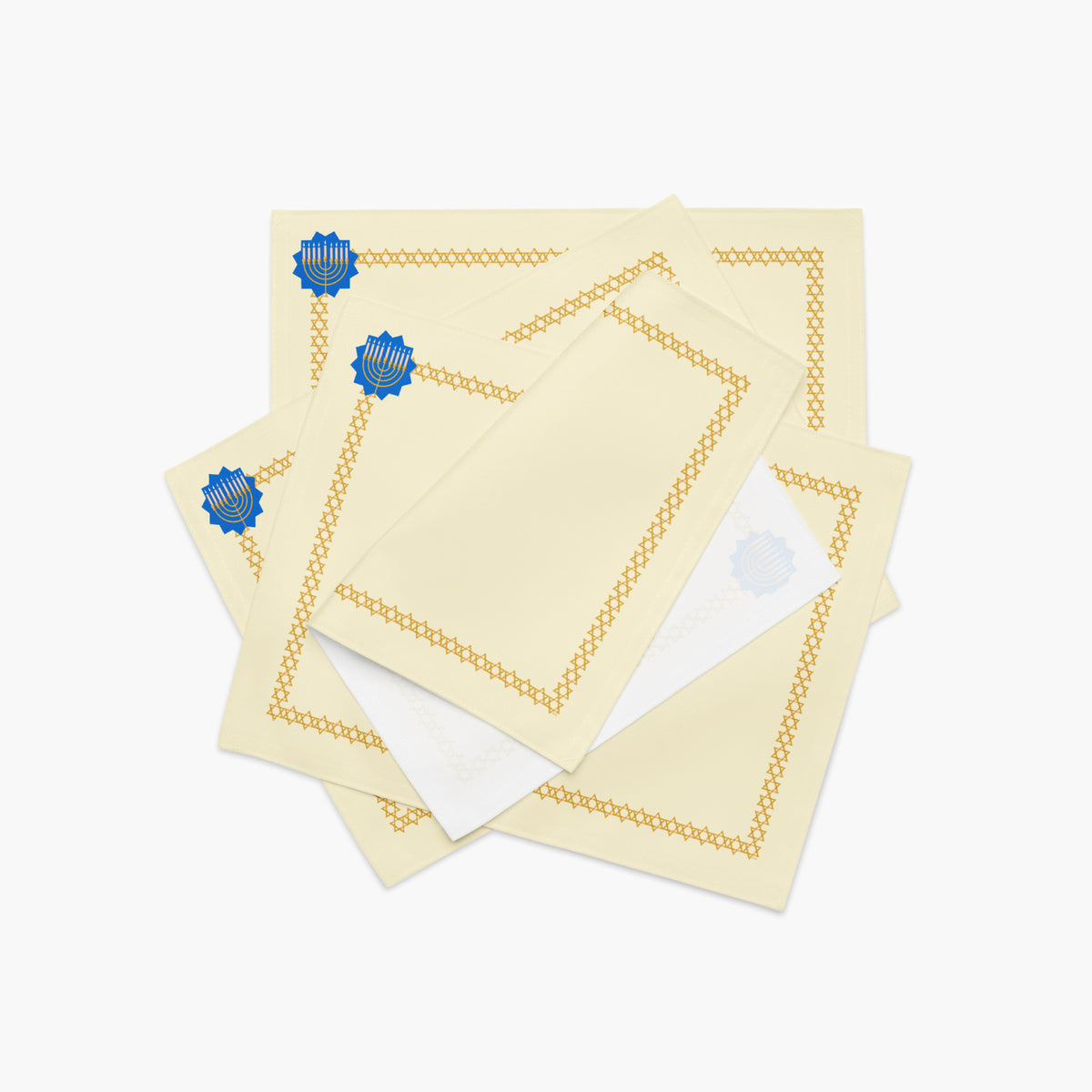 A stack of 4 rectangular cream-colored fabric placemat with a decorative border. The border features a repeating gold Star of David pattern around the edges, and a blue medallion with a gold menorah design in the top-left corner.