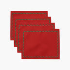 Four red rectangular with a decorative border of small green holly leaves and berries arranged in a staggered stack on a light gray background.