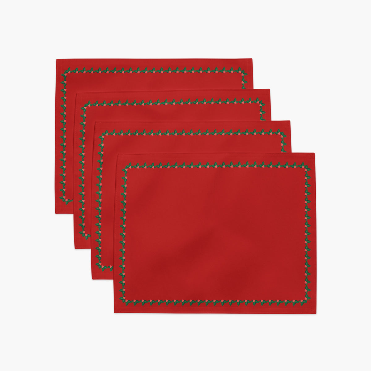 Four red rectangular with a decorative border of small green holly leaves and berries arranged in a staggered stack on a light gray background.