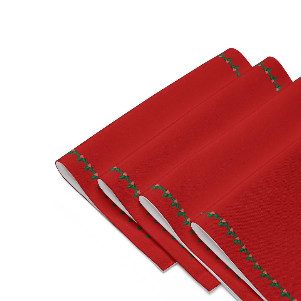 Four red rectangular with a decorative border of small green holly leaves and berries arranged folded in a staggered stack on a light gray background.