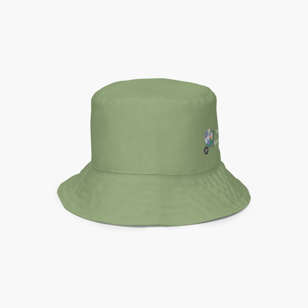 Green bucket hat with a small embroidered design on a white background