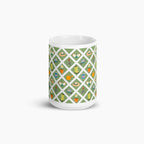 White mug with green garden lattice fence pattern on a white background