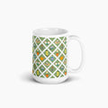 White mug with green garden lattice fence pattern on a white background