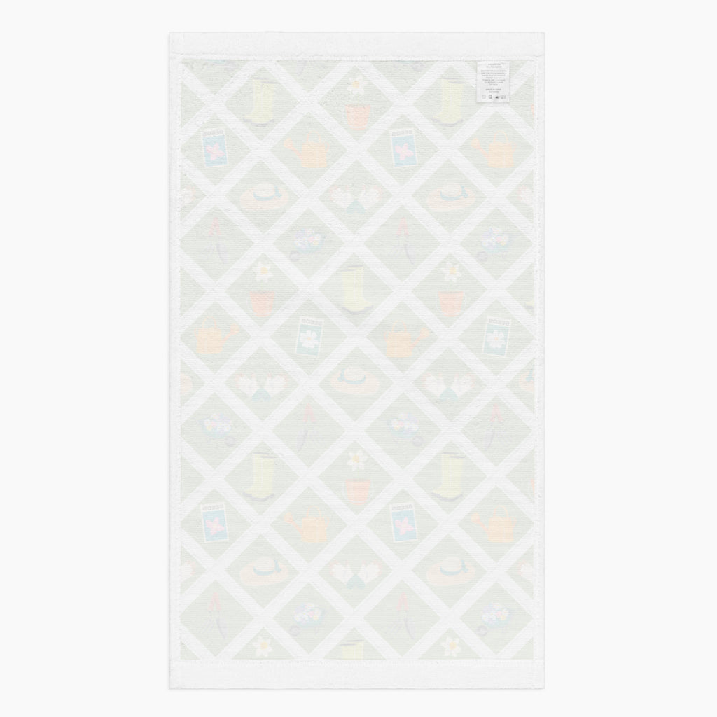White back of Cloth kitchen hand towel with green garden-themed pattern on a white background